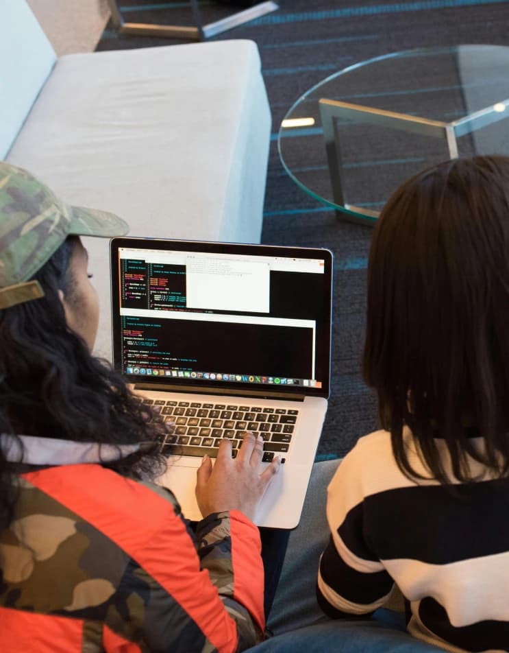 Students building a project together on a laptop