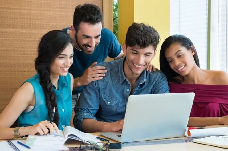 A student team coding together at a hackathon